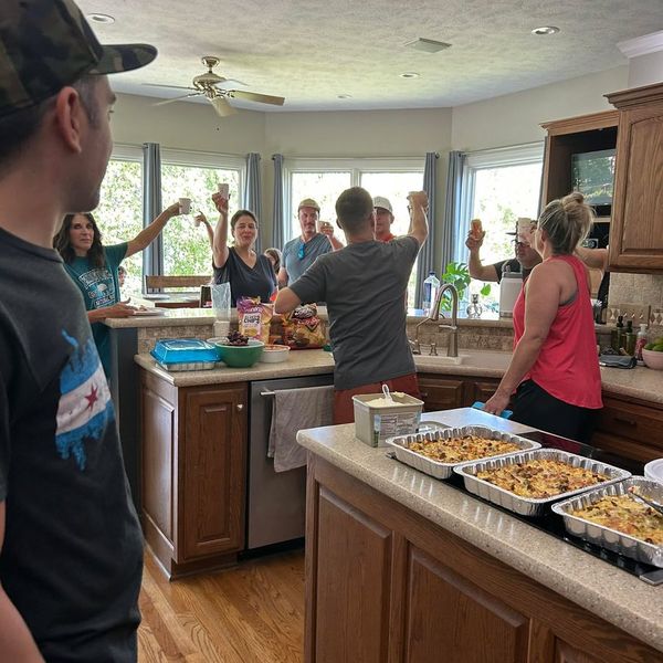 Family toasting in the kitchen with breakfast casseroles on the counter