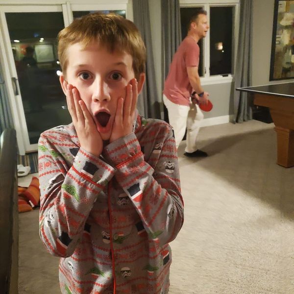 Kid in Star Wars onesie making a shocked face